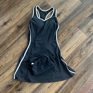 Size small. Black tennis/golf outfit. Black and white striped lining on sides.